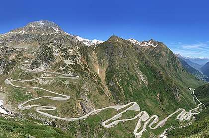 Photo shows the road that zig-zags up the Val Tremola toward the Gotthard Pass.