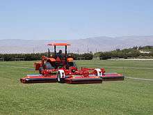 A typical roller mower operating on a sod grass farm