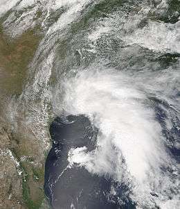 Satellite imagery of a large, disorganized tropical storm near peak intensity