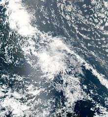 Satellite image of a tropical cyclone. The storm is a rather disorganized cluster of storms