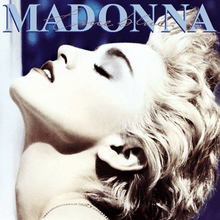 Madonna in white blond, short hair tilts her head back, with the album name appearing atop her image.