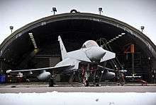 An No. 11 Squadron Eurofighter Typhoon outside a hardened aircraft shelter at Coningsby.