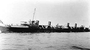 A black and white image of the Truxtun in open water.