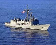A navy ship with the number 55 on it