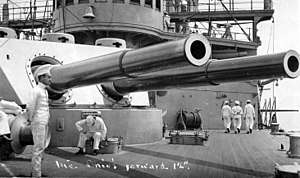 12"/40 guns of the ship's forward gun turret, photographed circa 1907-1908. Note Sailors strolling on deck; bell mounted on the pilothouse face; and 3-pounder guns mounted on the superstructure.