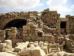 Ruins of a building of white stone.