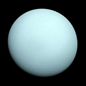 A whitish blue spherical planet against the black background of space
