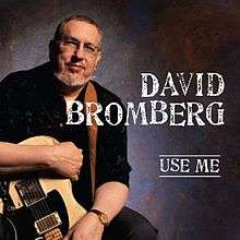David Bromberg, seated, and holding an electric guitar