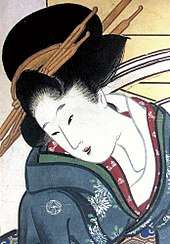 A finely-dressed Japanese woman wearing a kimono with a crest on the shoulder