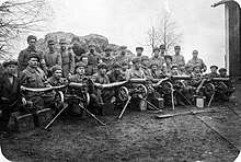 Around 30 soldiers of the paramilitary White Guard pose for the camera together with four Maxim heavy machine guns.