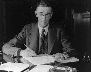 Vannevar Bush seated at a desk, sometime between 1940 and 1944.