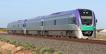 Silver, purple and green four-car train