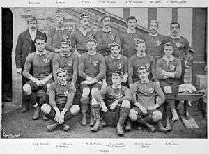 The full Welsh squad lining up for the purpose of a pre-match photo. Gould is seated centrally, dwarfed by his larger teammates.