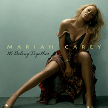 A black woman sitting in a bed in front of a light black background, and wearing a patterned dress. "Mariah Carey" is written on her image in green font, with "We Belong Together" written in black, cursive font below it.