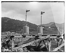 A pair of unlit Wells lights, on a wooden jetty