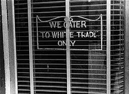 A sign reading "We Cater to White Trade Only.