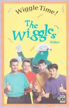 Cover showing four of The Wiggles doing their thumbs up with Dorothy the Dinosaur at the back holding her bag.