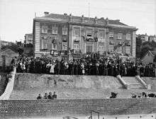 A black and white photo of a crowd gathered outside the William Booth Memorial Training College building.
