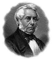 A white-haired man in a suit and bowtie faces the right.