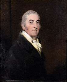 Painting of a middle-aged man with short grey hair, facing slightly toward the right, but head turned toward the observer