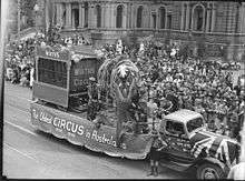 black and white photograph of Sydney street parade with an elephant on a circus float