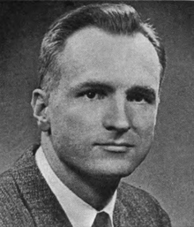 A black-and-white photo of Hudnut dressed in a suit