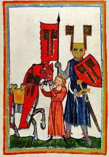 Medieval knight with a boy holding his horse.