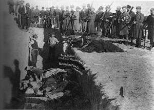 U.S. Soldiers putting Lakota corpses in common grave