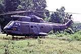 A large helicopter in a jungle clearing