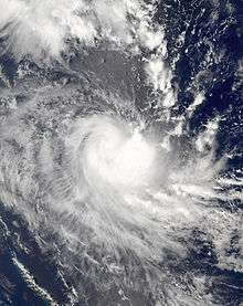 Satellite image of a developing Tropical cyclone in the Coral Sea. Clouds extend north-eastwards over the open ocean and south-eastwards towards New Caledonia.