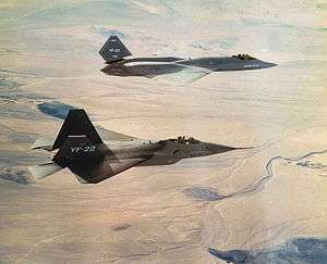 Two different jet aircraft in flight towards right of screen.