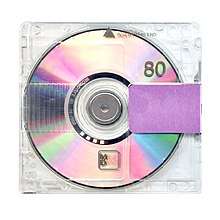 Cover art for Yandhi, which features a MiniDisc enclosed in a clear case, sealed off with purple tape