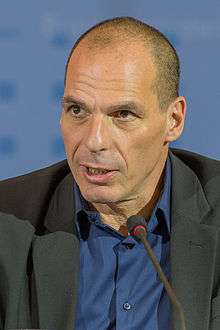 Photograph of Yanis Varoufakis sitting in front of microphone