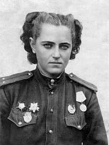 mid-war portrait photograph of Zhigulenko. On her military uniform she is wearing her guards pin, one Order of the Patriotic War, one Order of the Red Star, one Order of the Red Banner, and the Medal "For the Defence of the Caucasus"