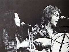 Yoko Ono and John Lennon performing