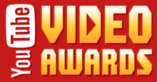 The words "YouTube VIDEO AWARDS" written against a red background. "YouTube" is written vertically against the left-hand side of the image. "You" is written in a white font"; "Tube" is written in a red font within a white, rounded rectangle. "VIDEO AWARDS" is written in a yellow-white font. The middle of the D in "VIDEO" is a right-pointing triangle, like a "Play" logo.