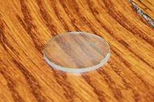 A transparent disc sitting on a wooden table