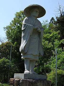 A status of Ennin, an important disciple of Saicho with blue sky in the background, facing right