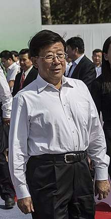 a man wearing glasses and a white shirt