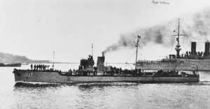 a black and white photograph of a small ship underway