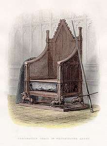 A wooden throne resting on four carved lions. A compartment under the seat holds a large rock. On the right a sword leans up against the chair, on the left a great slab.